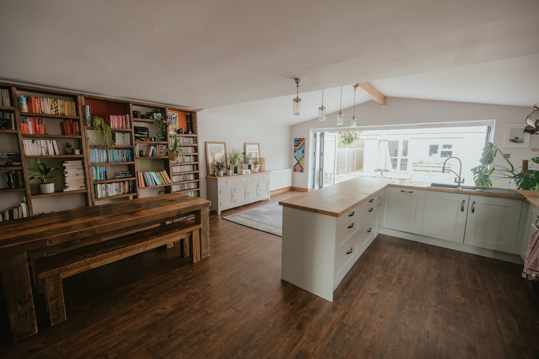 A kitchen shelf lined with books beside a window, where the books live between lessons